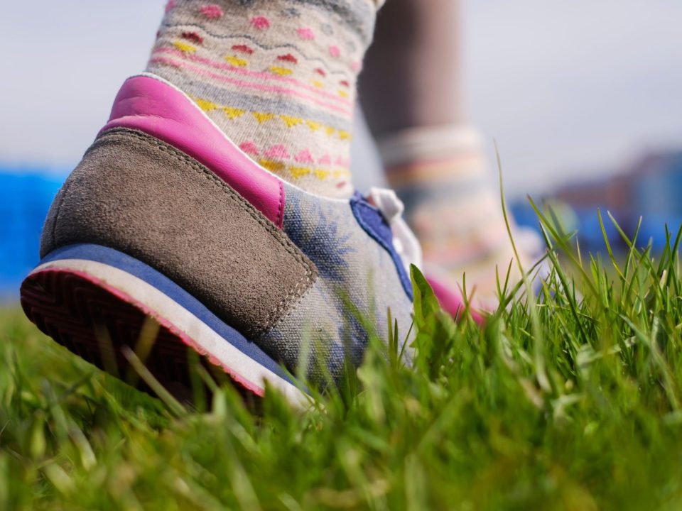 idratazione in primavera, immagine di scarpe da ginnastica su prato verde